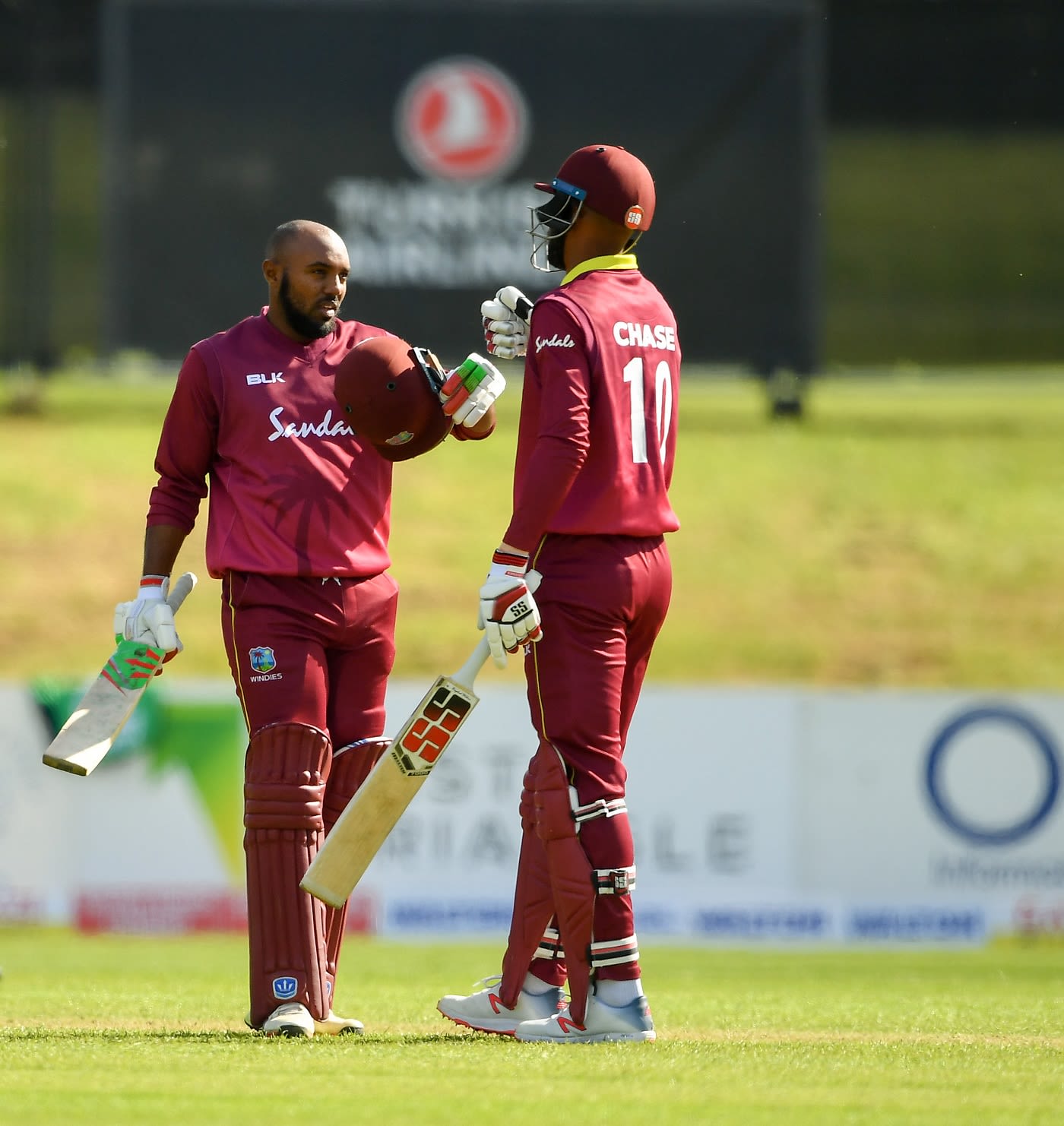 Sunil Ambris punches gloves with Roston Chase after his maiden ODI century