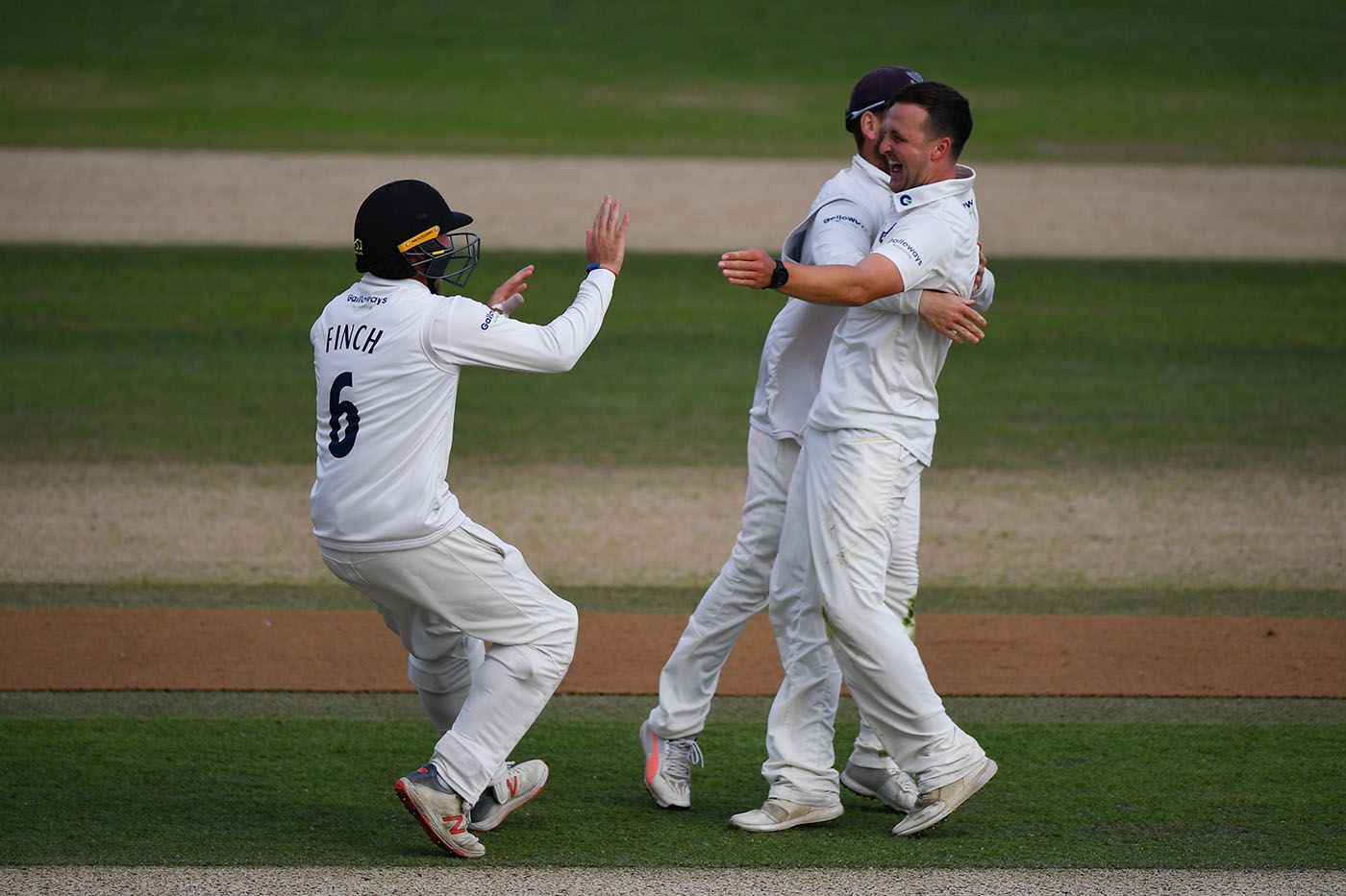 Elliot Hooper celebrates a maiden first-class wicket