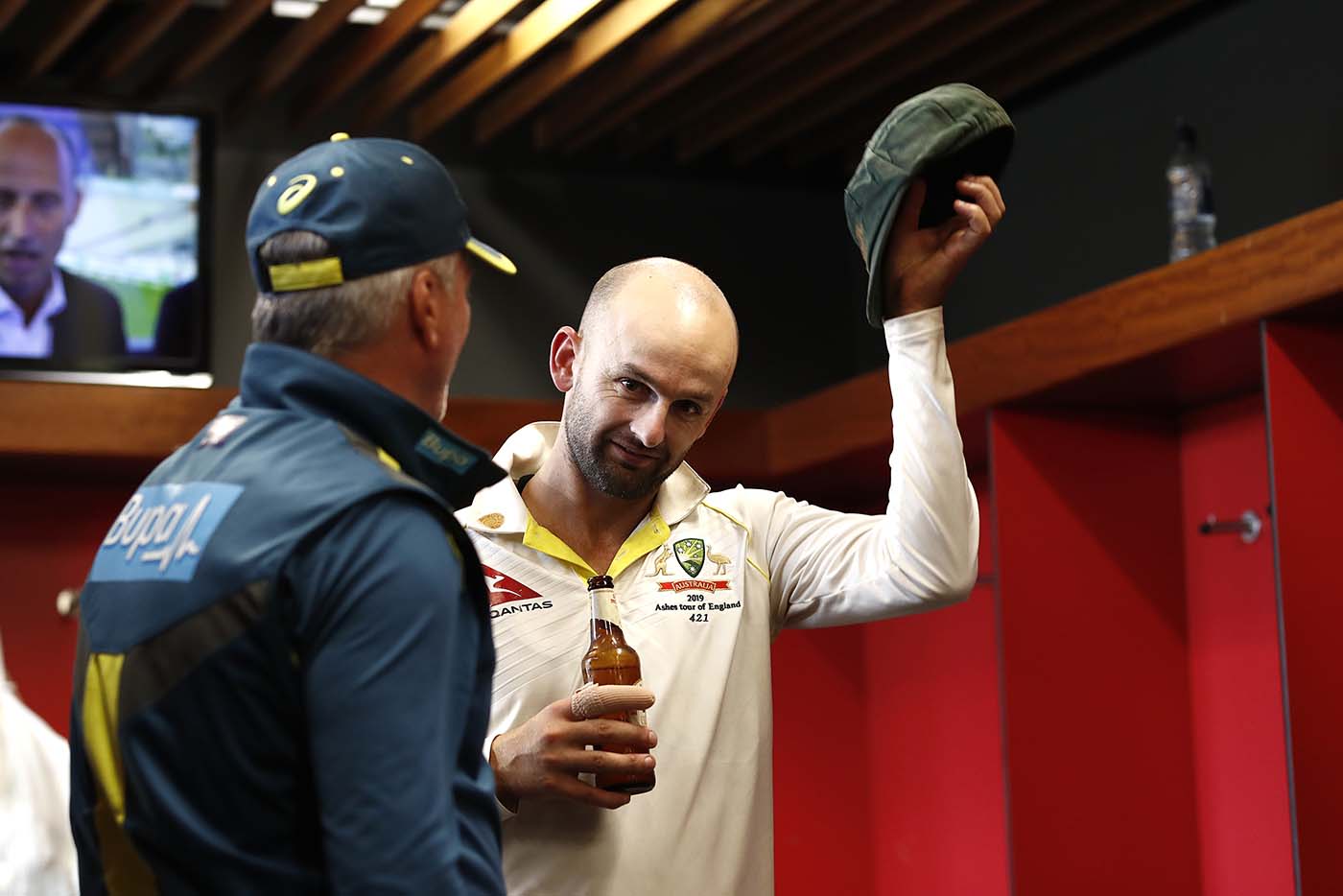 Nathan Lyon doffs his hat as Steve Waugh looks on