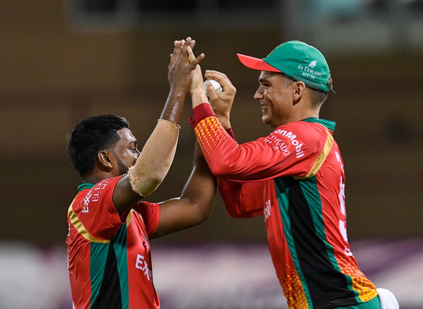 Chandrapaul Hemraj and Chris Green celebrate the dismissal of Glenn Phillips
