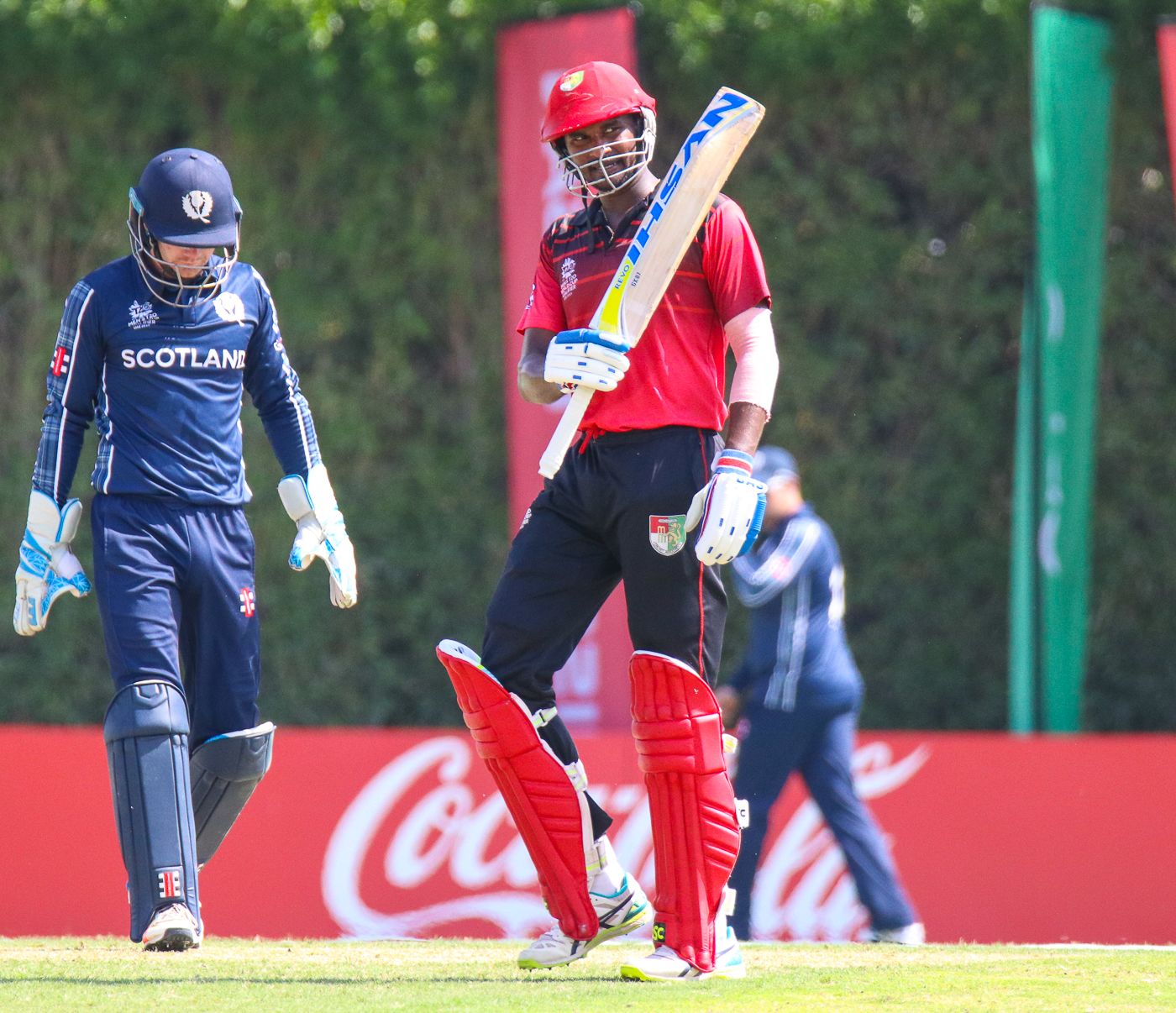 Surendran Chandramohan raises his bat after reaching a half-century