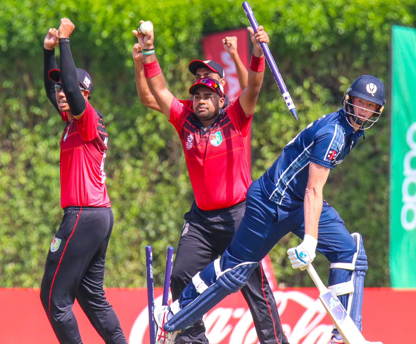 Singapore's Aritra Dutta rips out the stumps with ball in hand to end the match