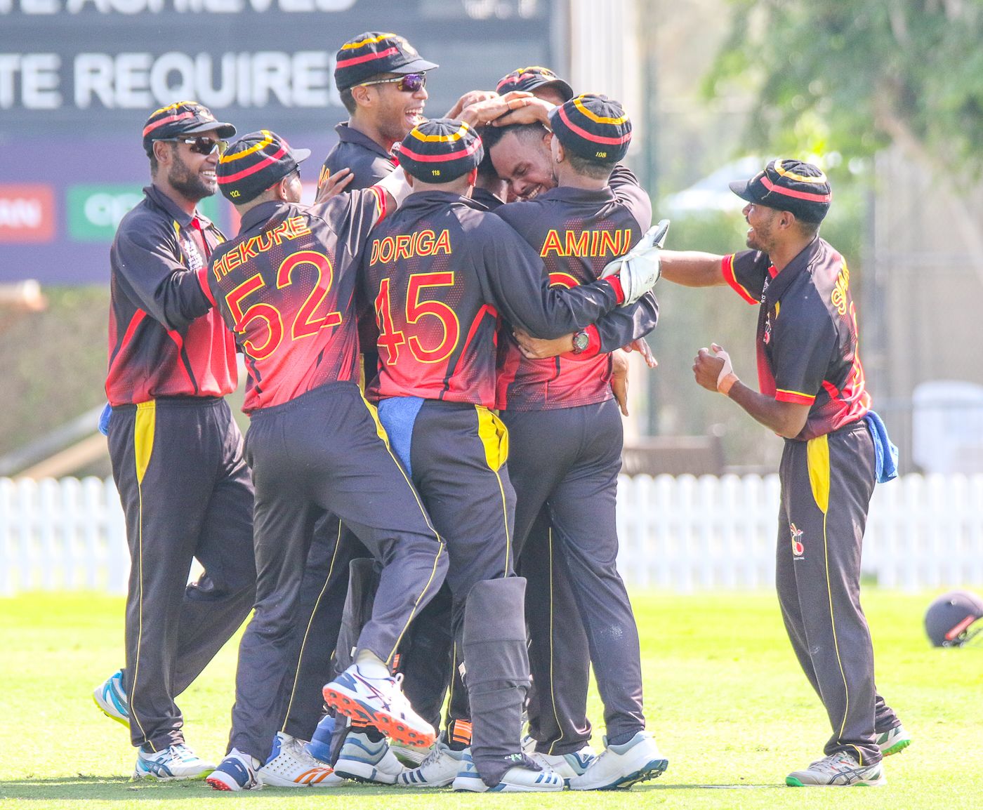 Norman Vanua is mobbed after taking a hat-trick against Bermuda in PNG's opening match