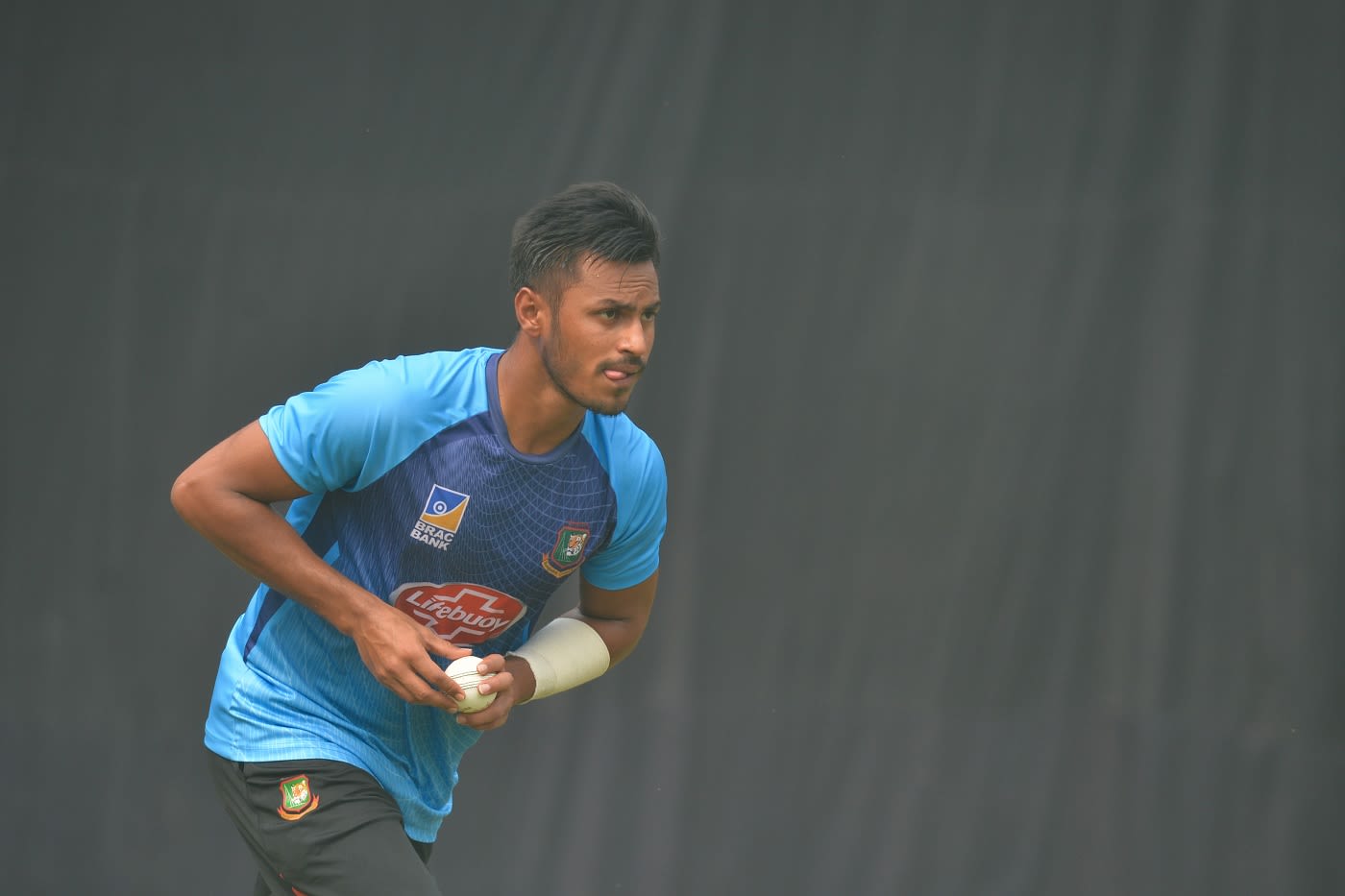 Abu Hider runs in to bowl during a practice session