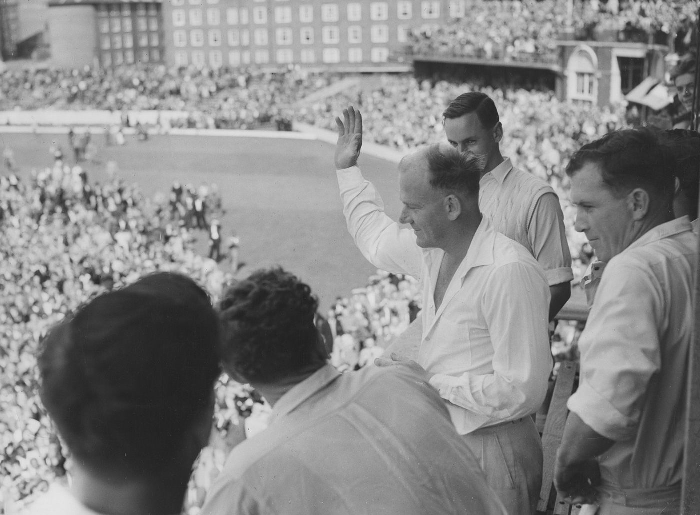 Tony Lock acknowledges the applause from the balcony