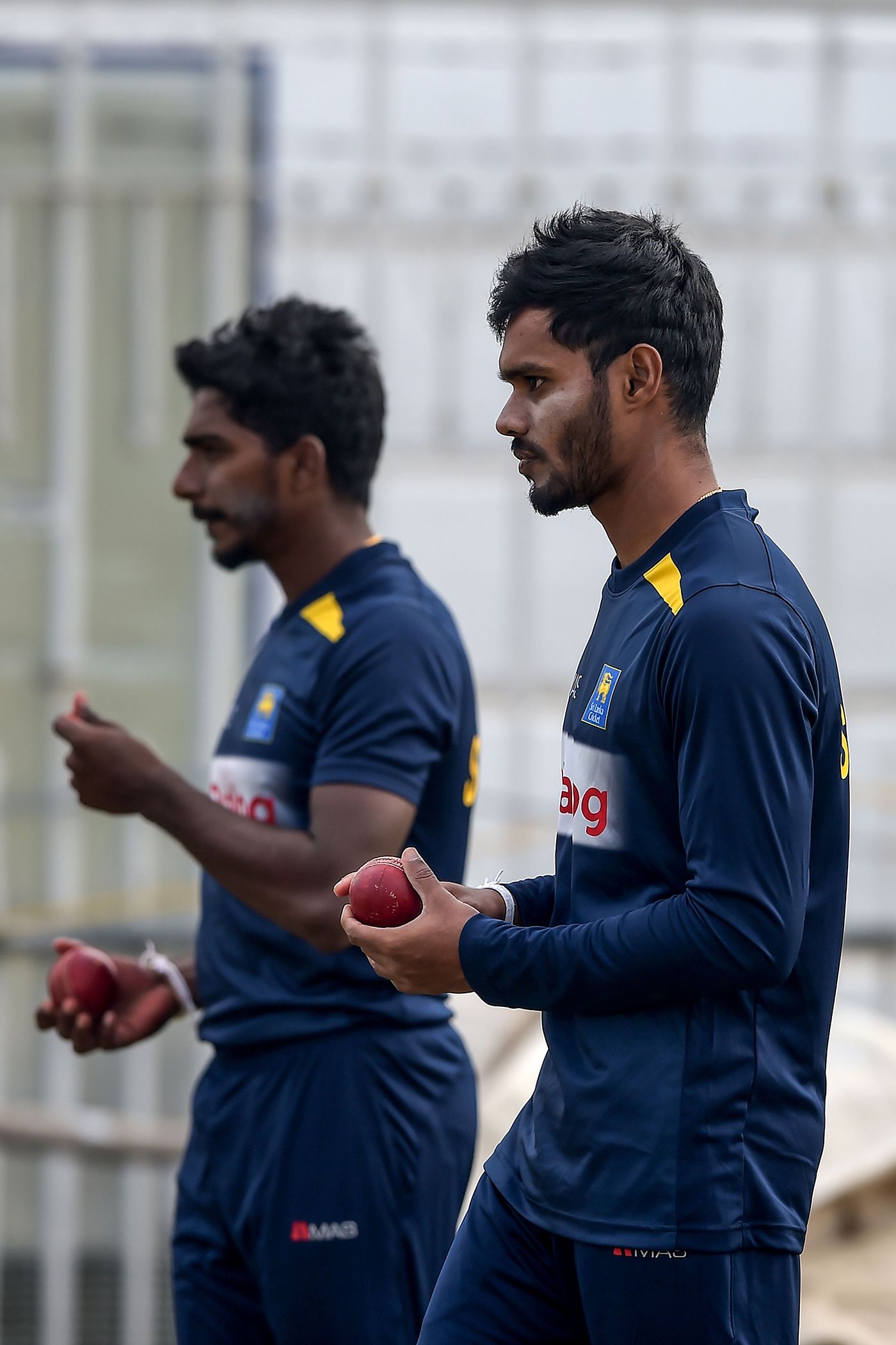 Dhananjaya de Silva and Lakshan Sandakan prepare to bowl at the nets