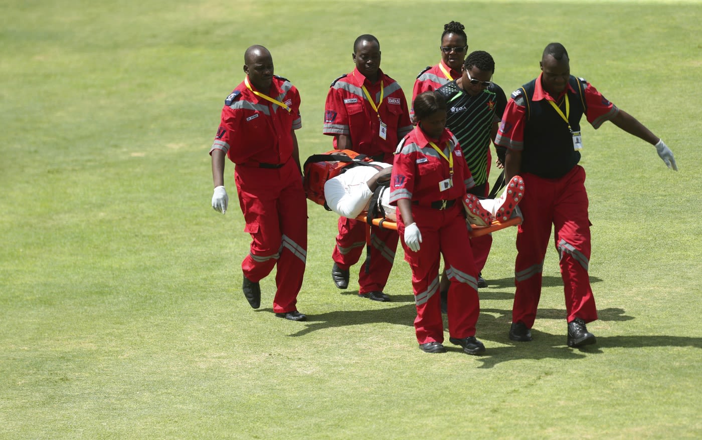 Kevin Kasuza is stretchered off the field after being hit on the helmet