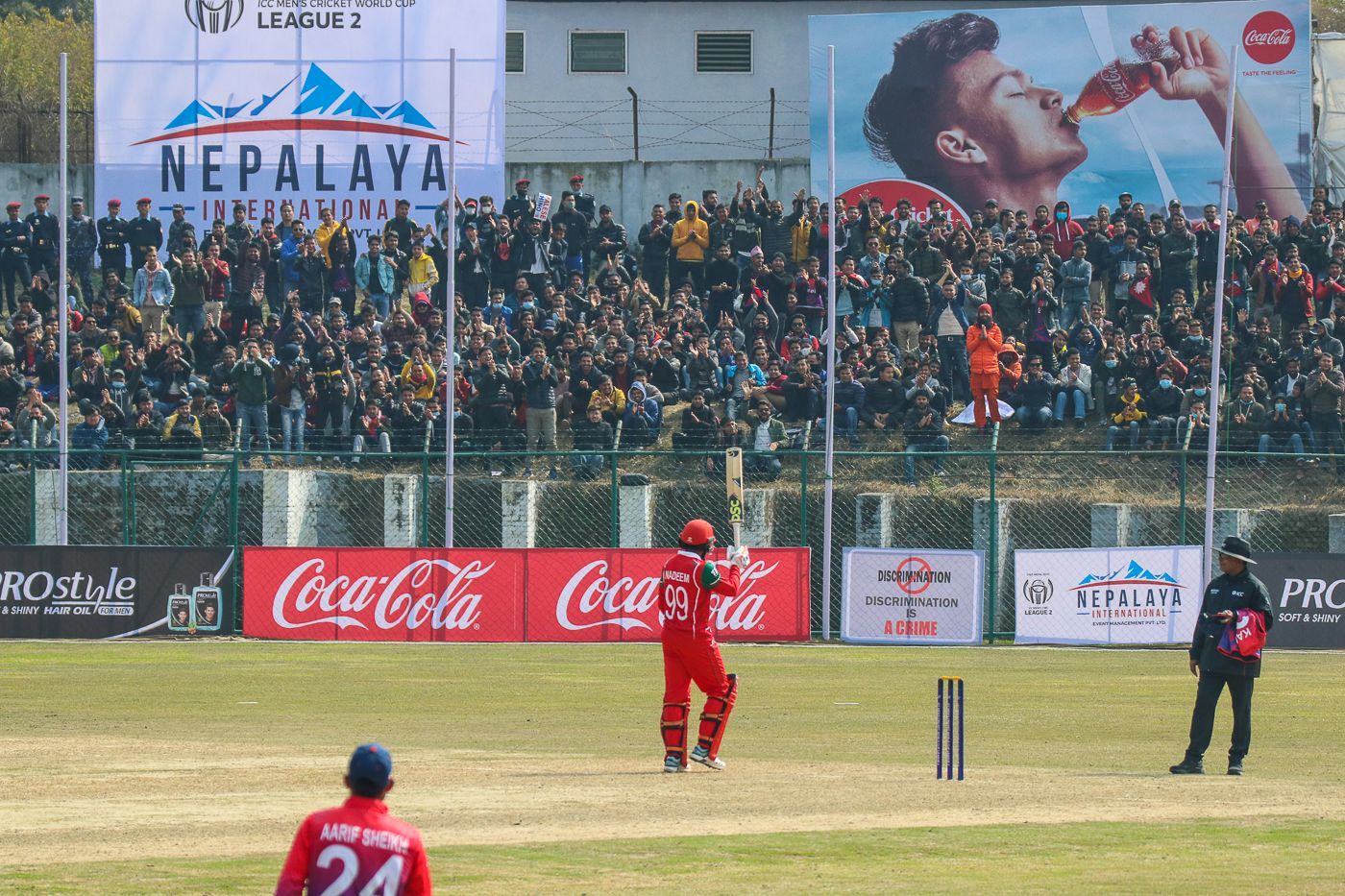 Oman's Mohammad Nadeem acknowledges applause from the Tribhuvan University Stadium crowd after reaching his fifty