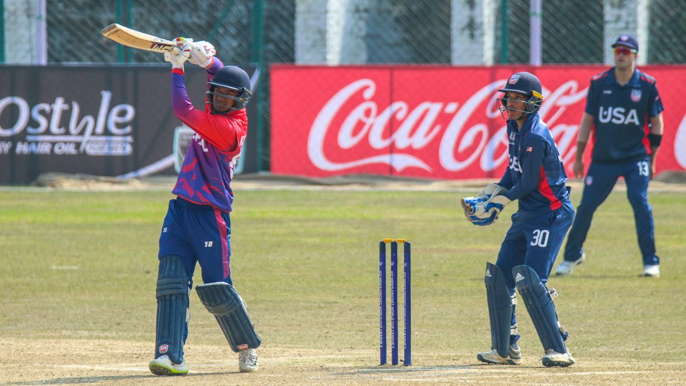 Kushal Malla drives down the ground for a boundary during his record-breaking half-century