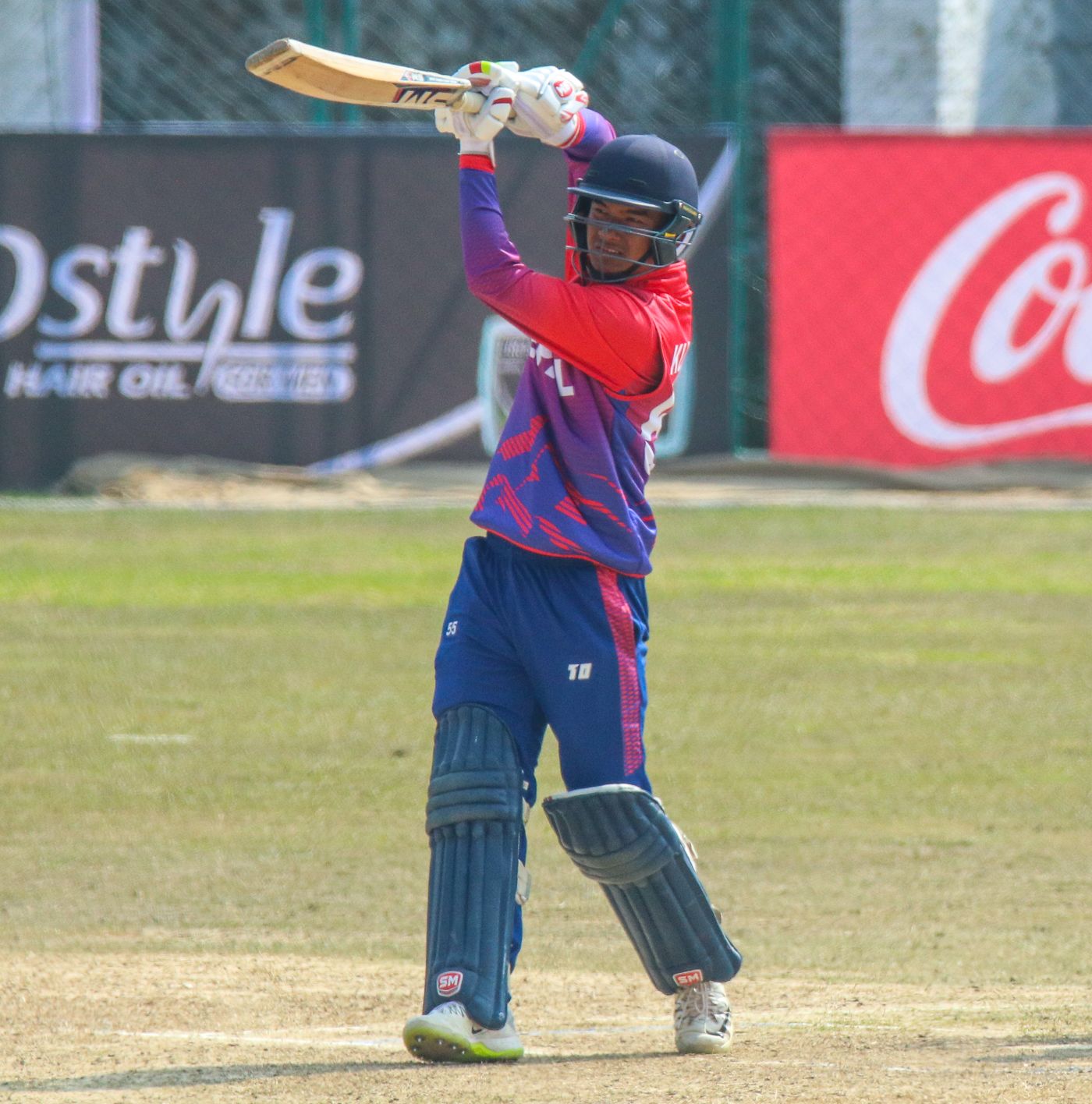 Kushal Malla drives over mid-off for a boundary