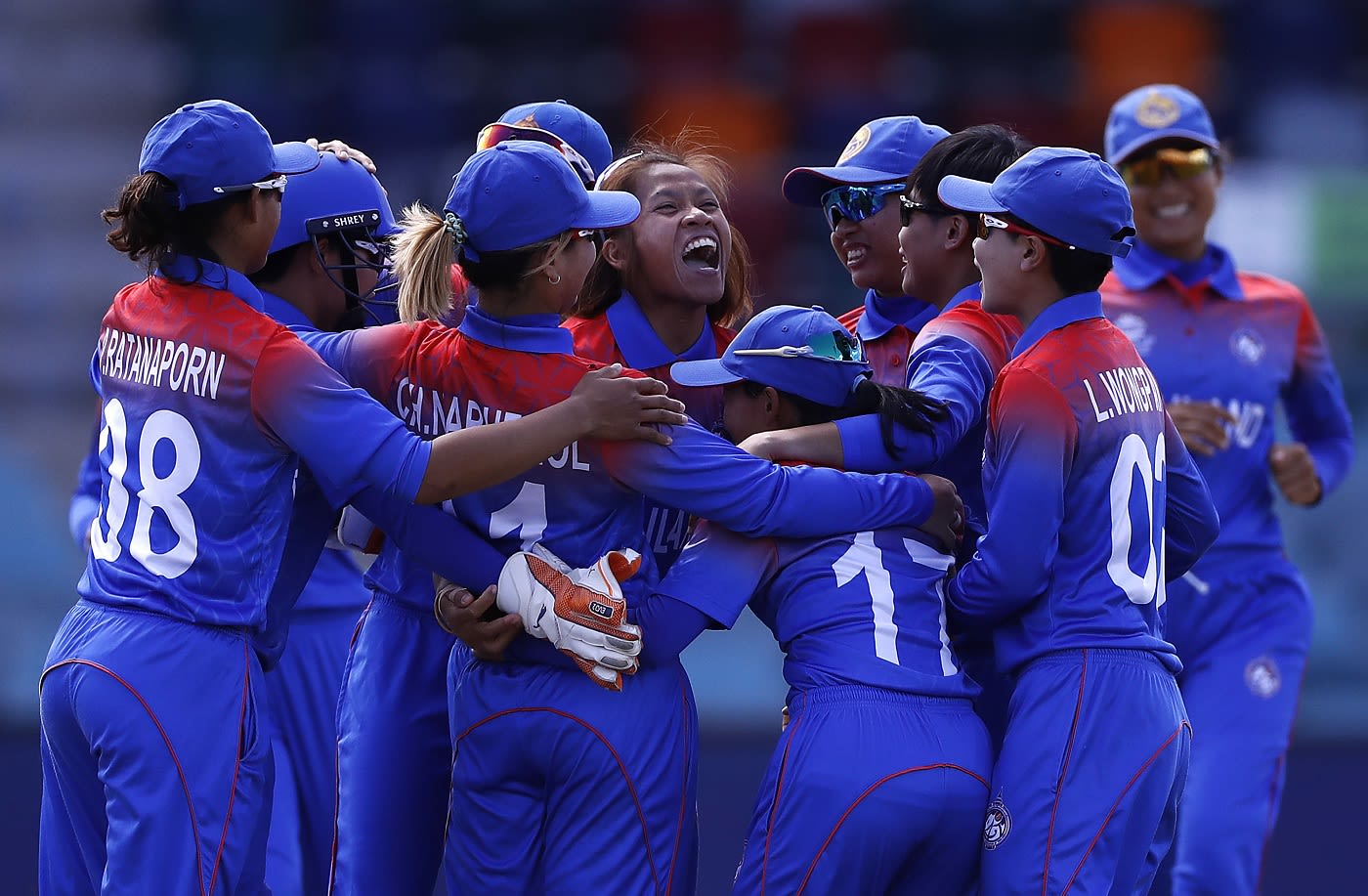 Nattaya Boochatham is mobbed by her team-mates after dismissing Amy Jones in the first over