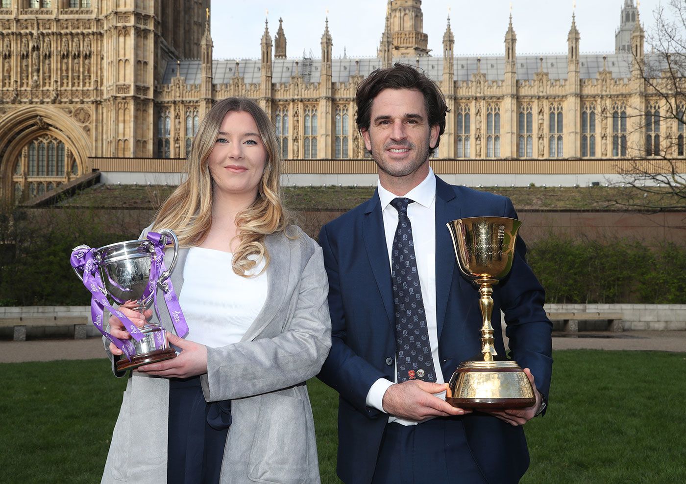 Lauren Griffiths and Ryan ten Doeschate with the Women's One Day Cup and County Championship trophies