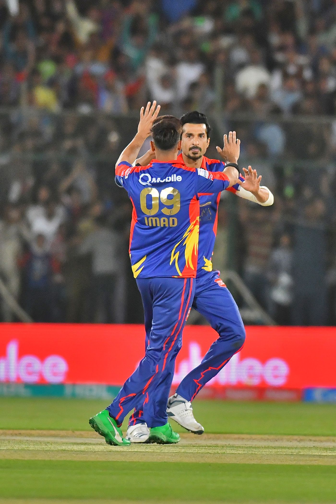 Umaid Asif celebrates a breakthrough with Imad Wasim