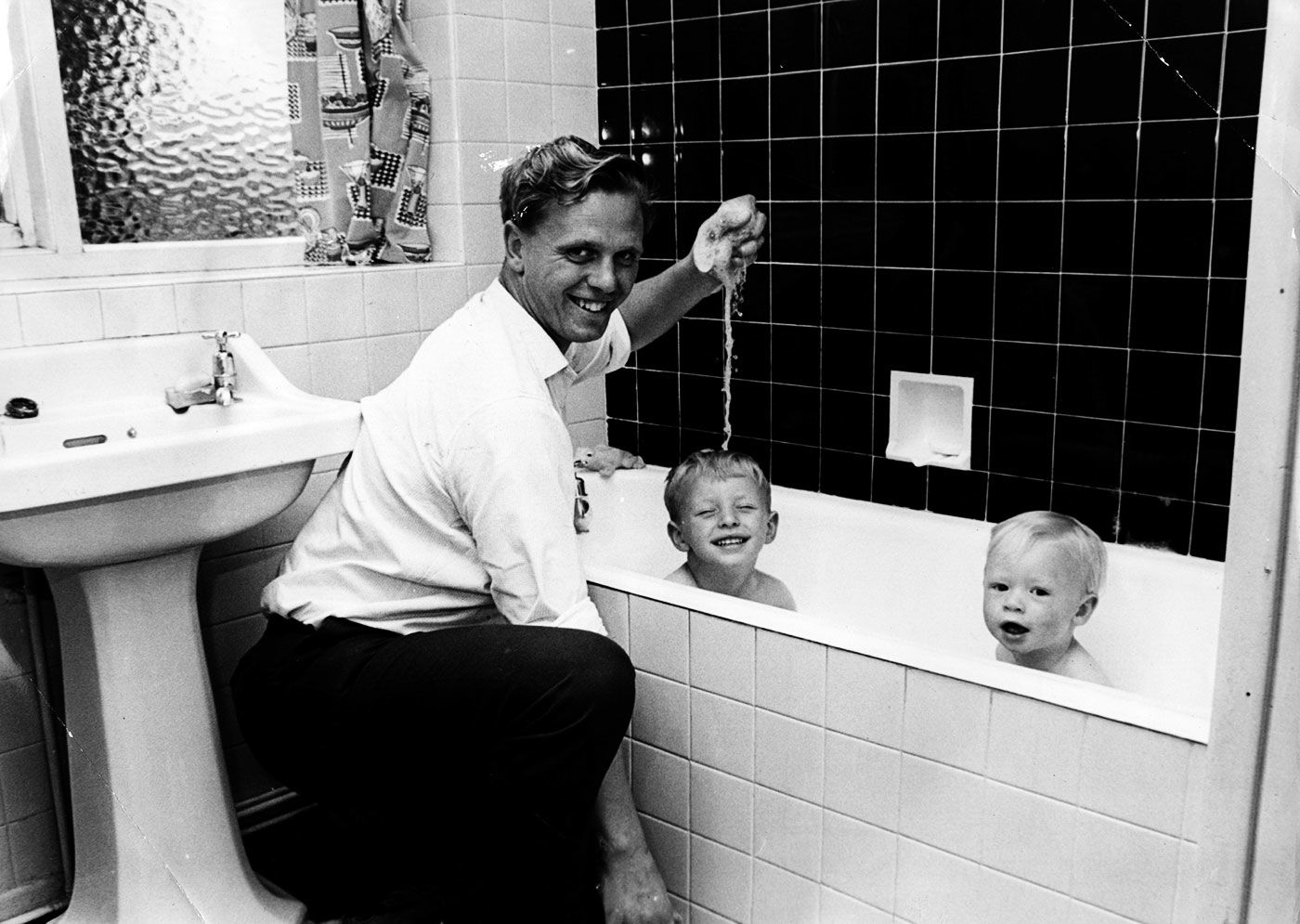 Ken Higgs gives his kids a bath