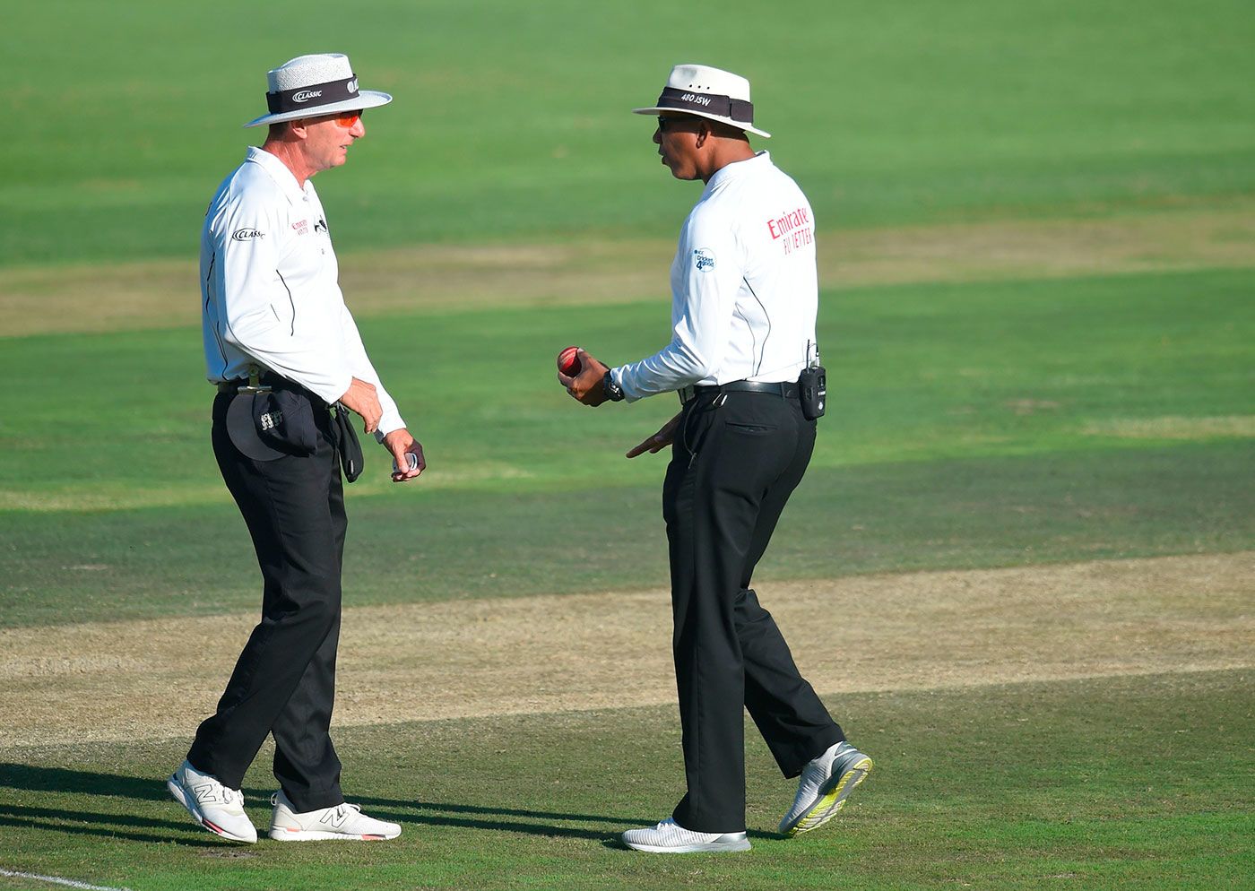 Umpires Rod Tucker and Joel Wilson inspect the ball