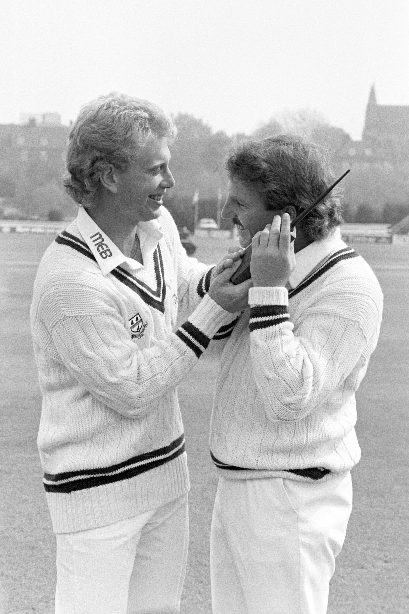 Graham Dilley and Ian Botham fool around with a mobile phone
