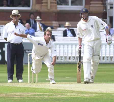 Mike Smith bowling from the Pavilion end at Lord's