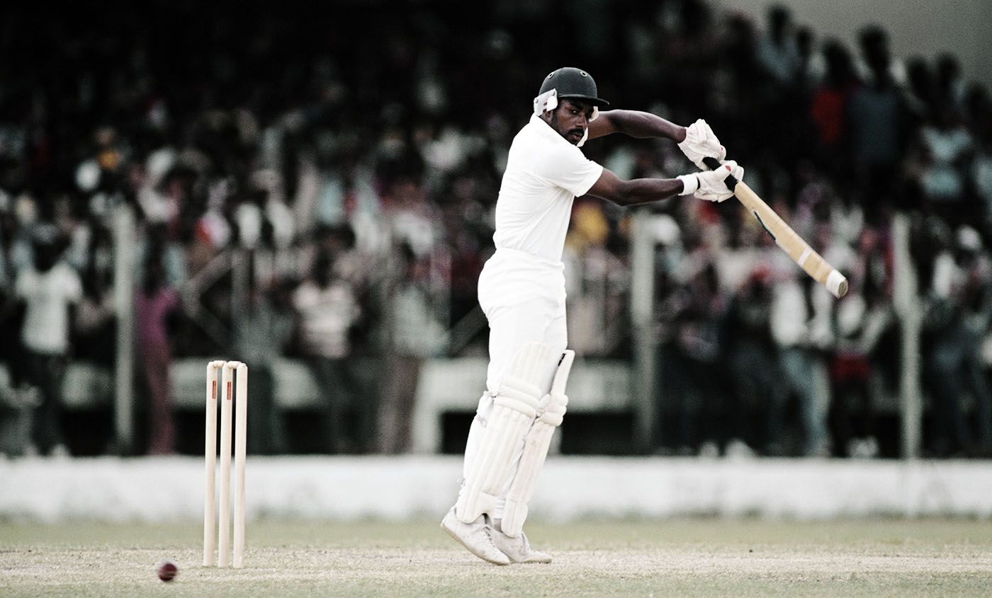 Roland Butcher plays a shot