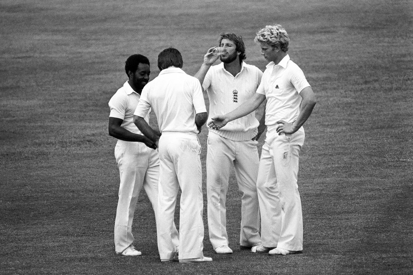 Roland Butcher, the 12th man, brings out drinks for his team-mates