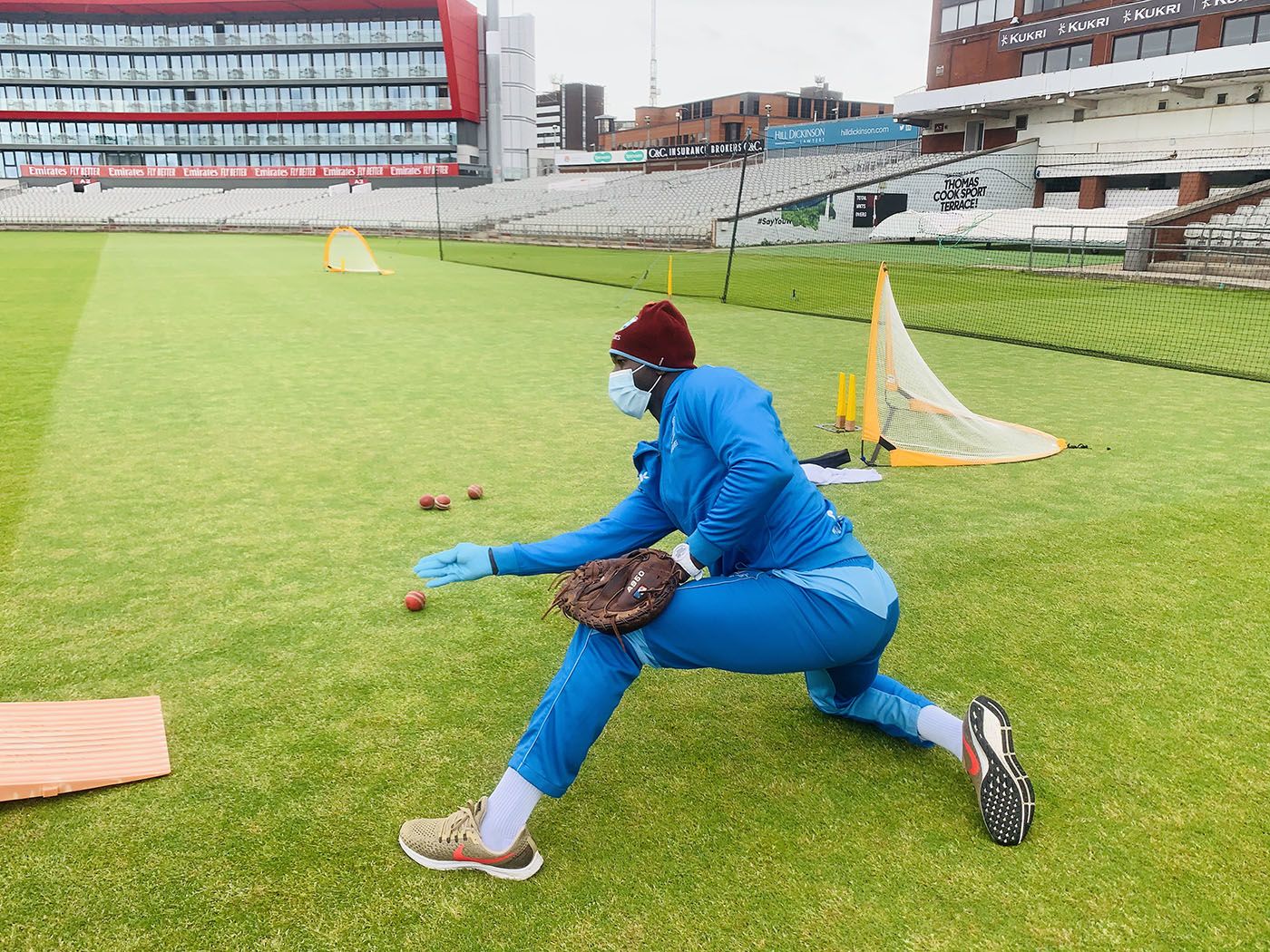 West Indies fielding coach Rayon Griffith wears PPE while conducting a drill