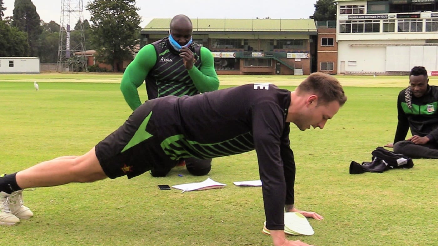Kyle Jarvis doing push-ups under the watchful eye of fitness trainer Walter Karimanzira