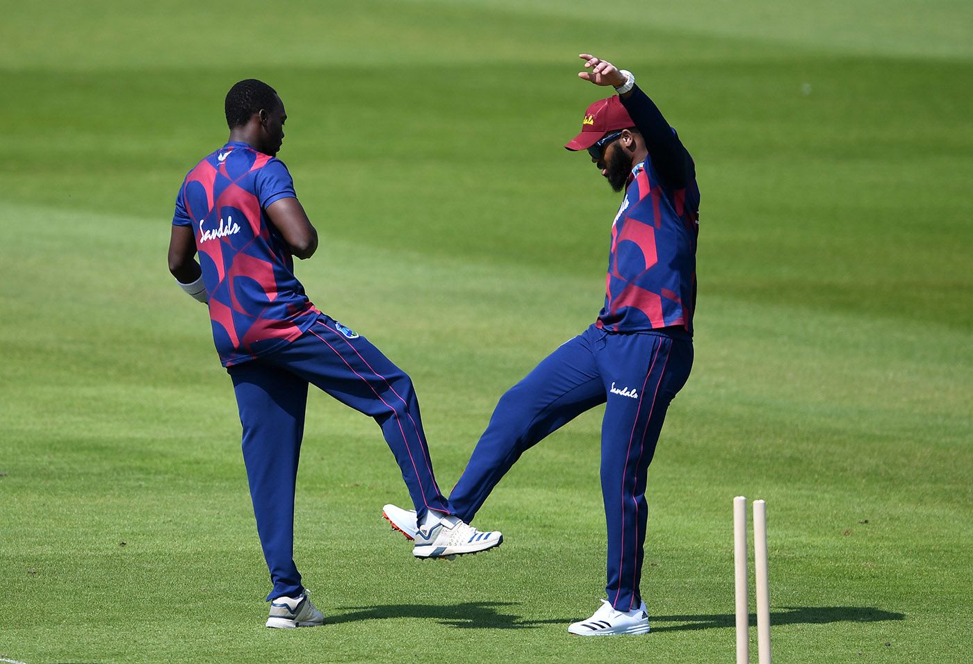 Marquino Mindley celebrates with John Campbell after claiming the wicket of Jermaine Blackwood