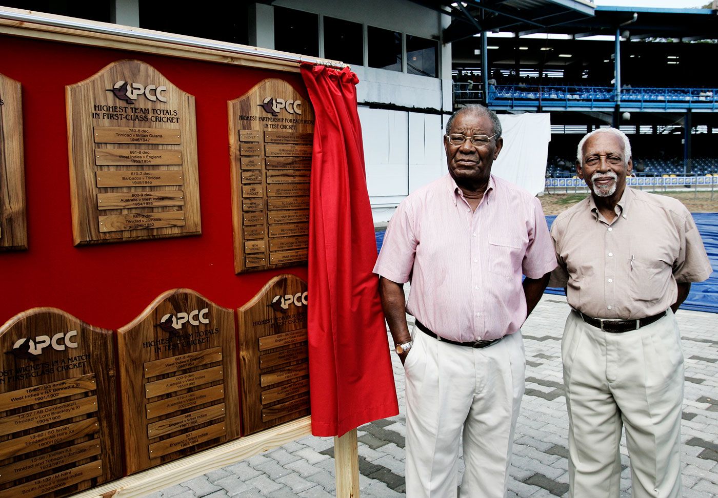 Sir Everton Weekes (left) and Andy Ganteaume stand in front of a display honouring Sir Frank Worrell during a ceremony in Port-of-Spain