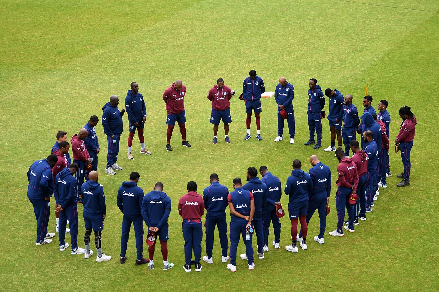 The West Indies team observes a minute's silence in memory of Sir Everton Weekes