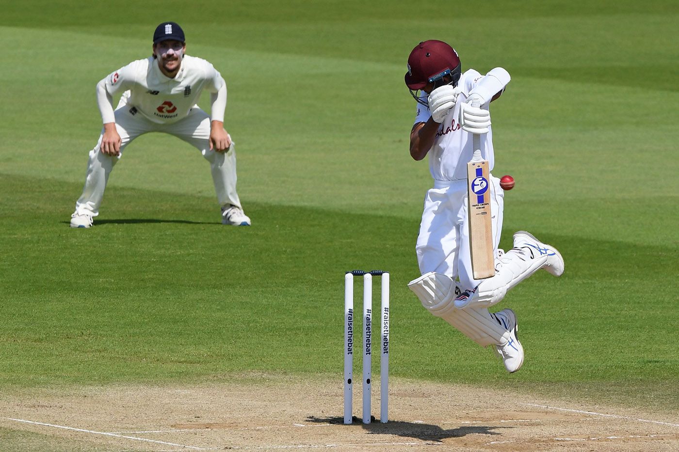 Shane Dowrich leaps to evade a short ball from Jofra Archer