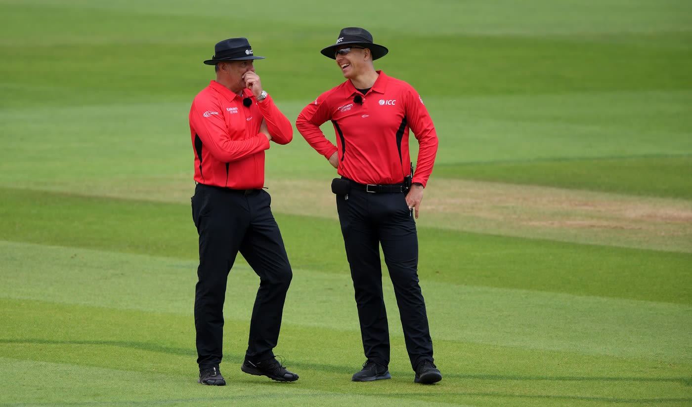 Umpires David Millns and Alex Wharf share a lighter moment