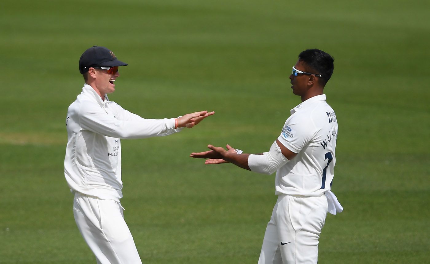 Thilan Walallawita celebrates with Nick Gubbins after taking the wicket of Mark Stoneman 