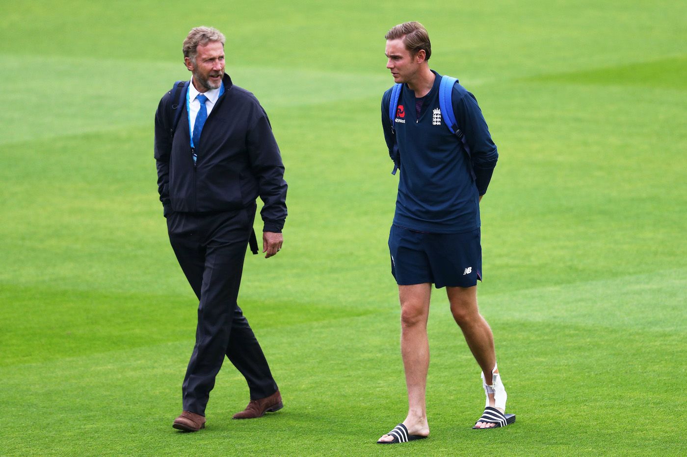 Chris Broad leaves the field at the end of the days play with Stuart Broad