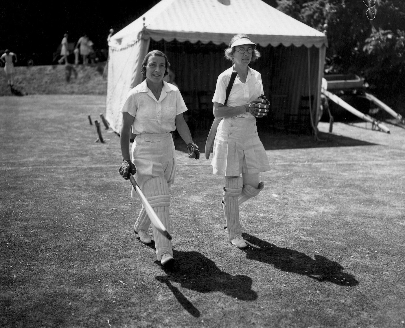 Betty Snowball (left) and T Dutton walk out to open the batting