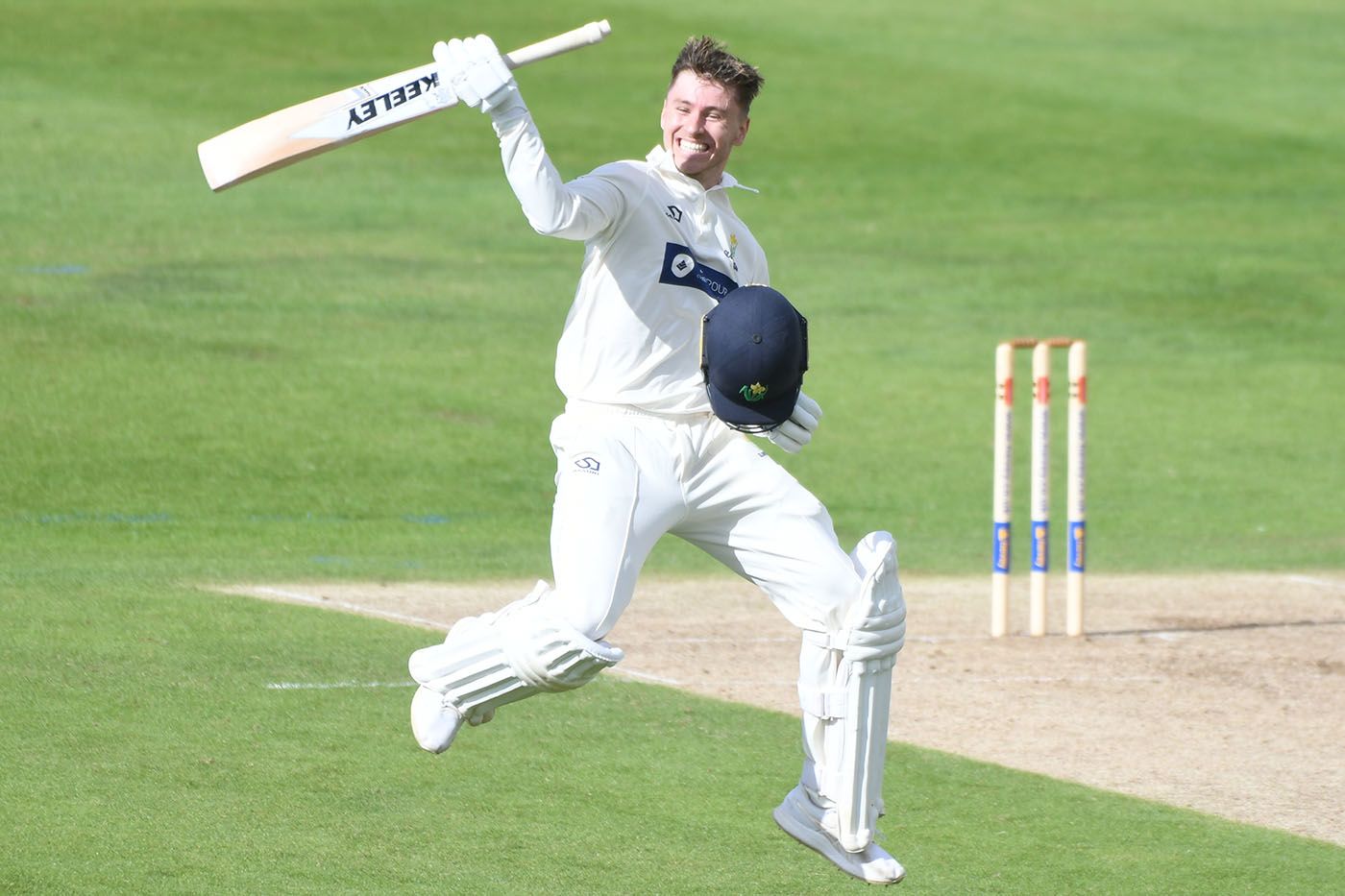 Callum Taylor celebrates after bringing up his hundred on first-class debut
