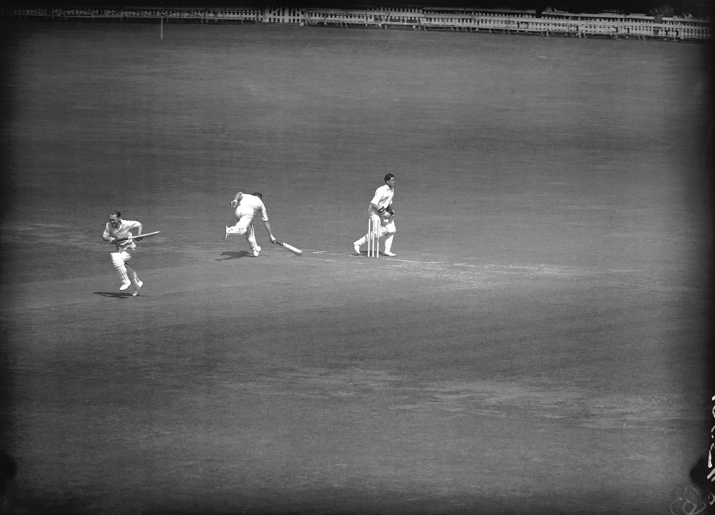 Warwickshire's Charlie Grove is run out by Middlesex's Michael Laws as Eric Hollies sprints to the other end