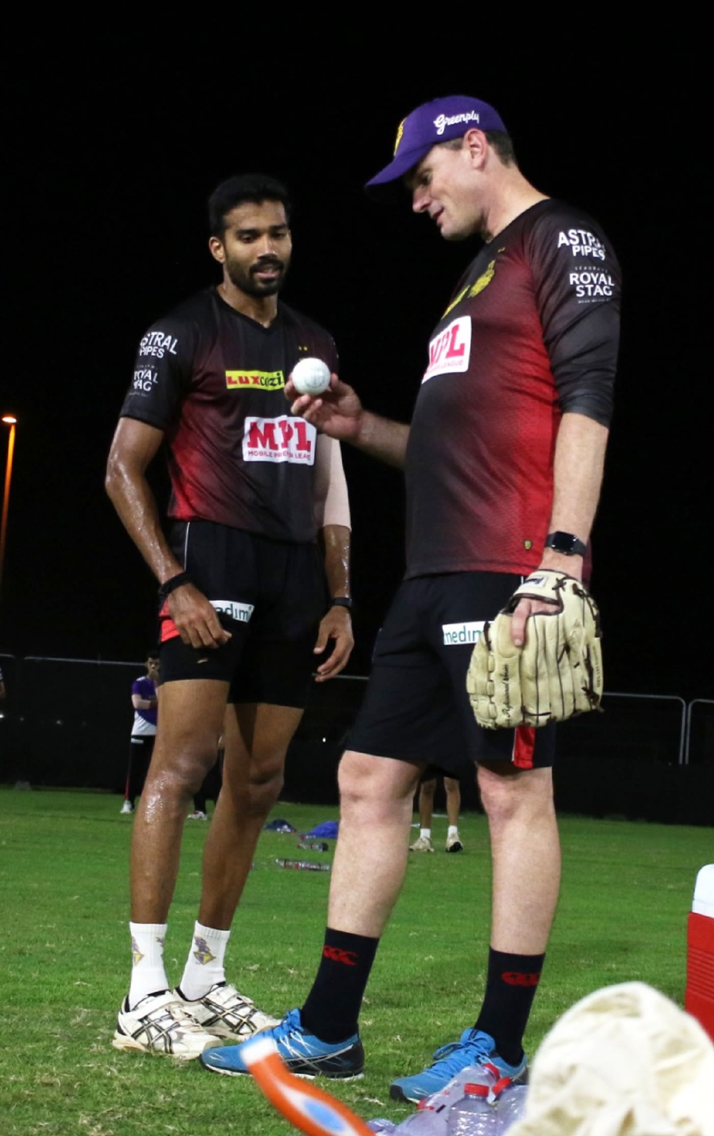 Sandeep Warrier chats to Kyle Mills during training