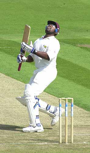 Adrian Rollins looks up for the ball he has top edged, but it ends up in the hands of keeper Nixon so he is out, bowled Saggers.