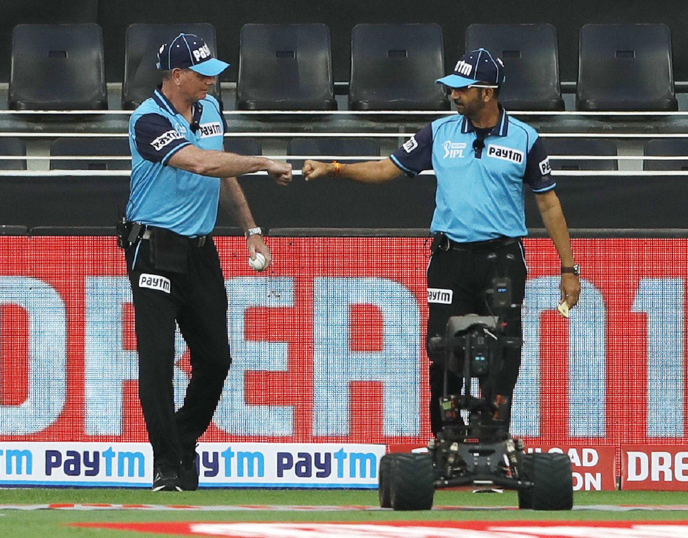 Umpires Paul Reiffel and Anil Chaudhary walk out onto the field