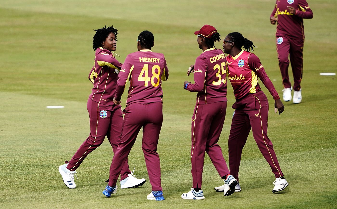 Sheneta Grimmond (extreme left) celebrates a wicket with her team-mates