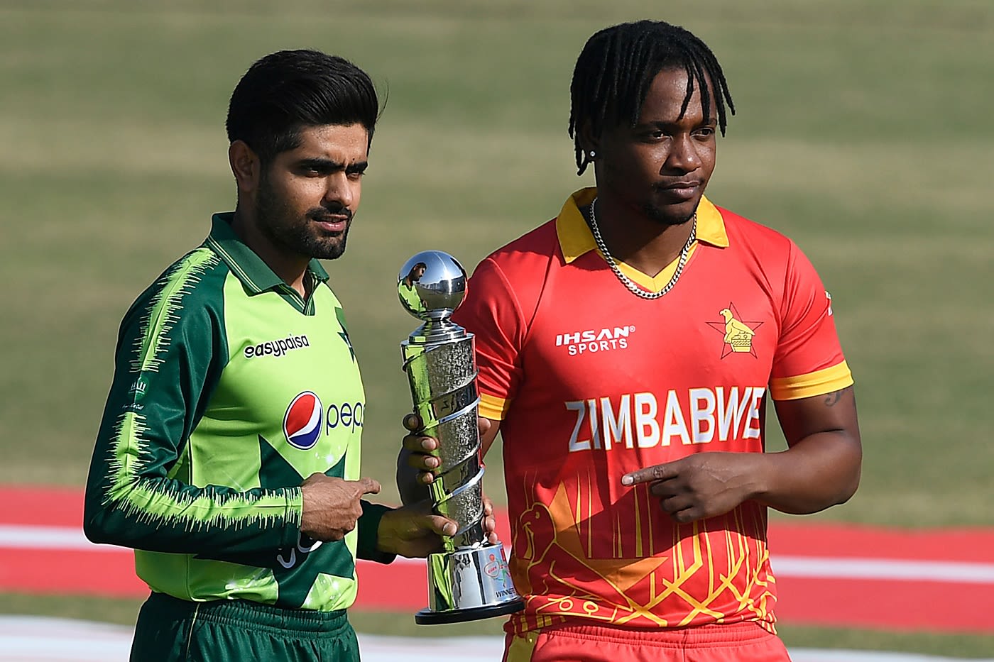 Captains Babar Azam and Chamu Chibhabha pose with the T20I trophy