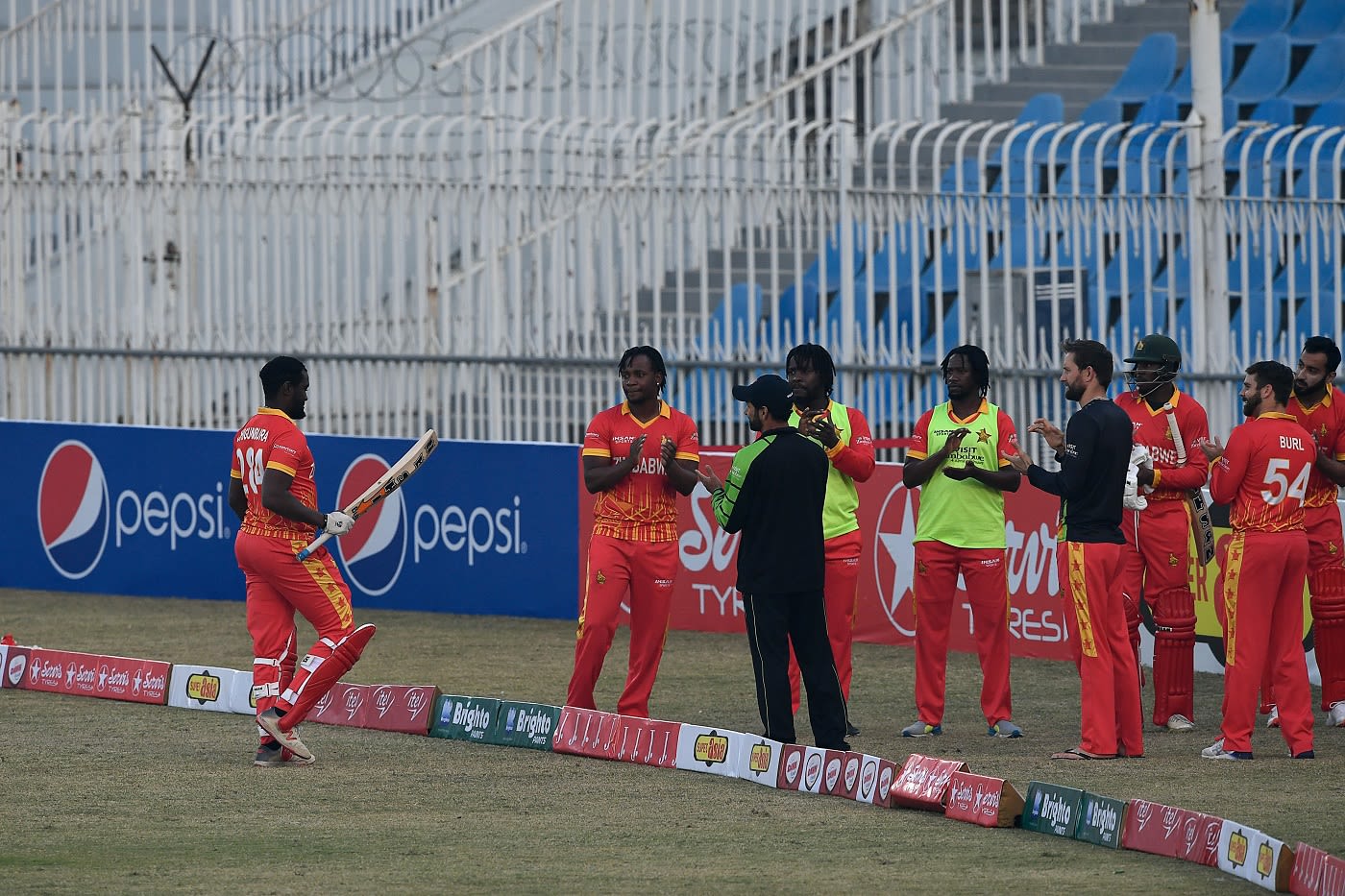 The Zimbabwe players give Elton Chigumbura a guard of honour in his last international game