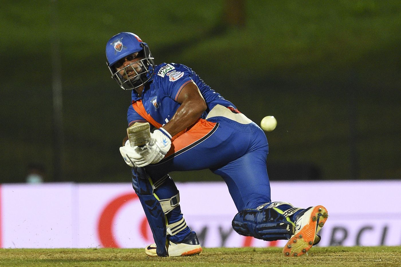 Asela Gunaratne sweeps during his half-century