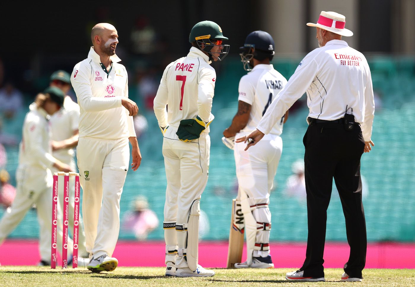 Tim Paine has a word with umpire Paul Wilson after a review in Nathan Lyon's over