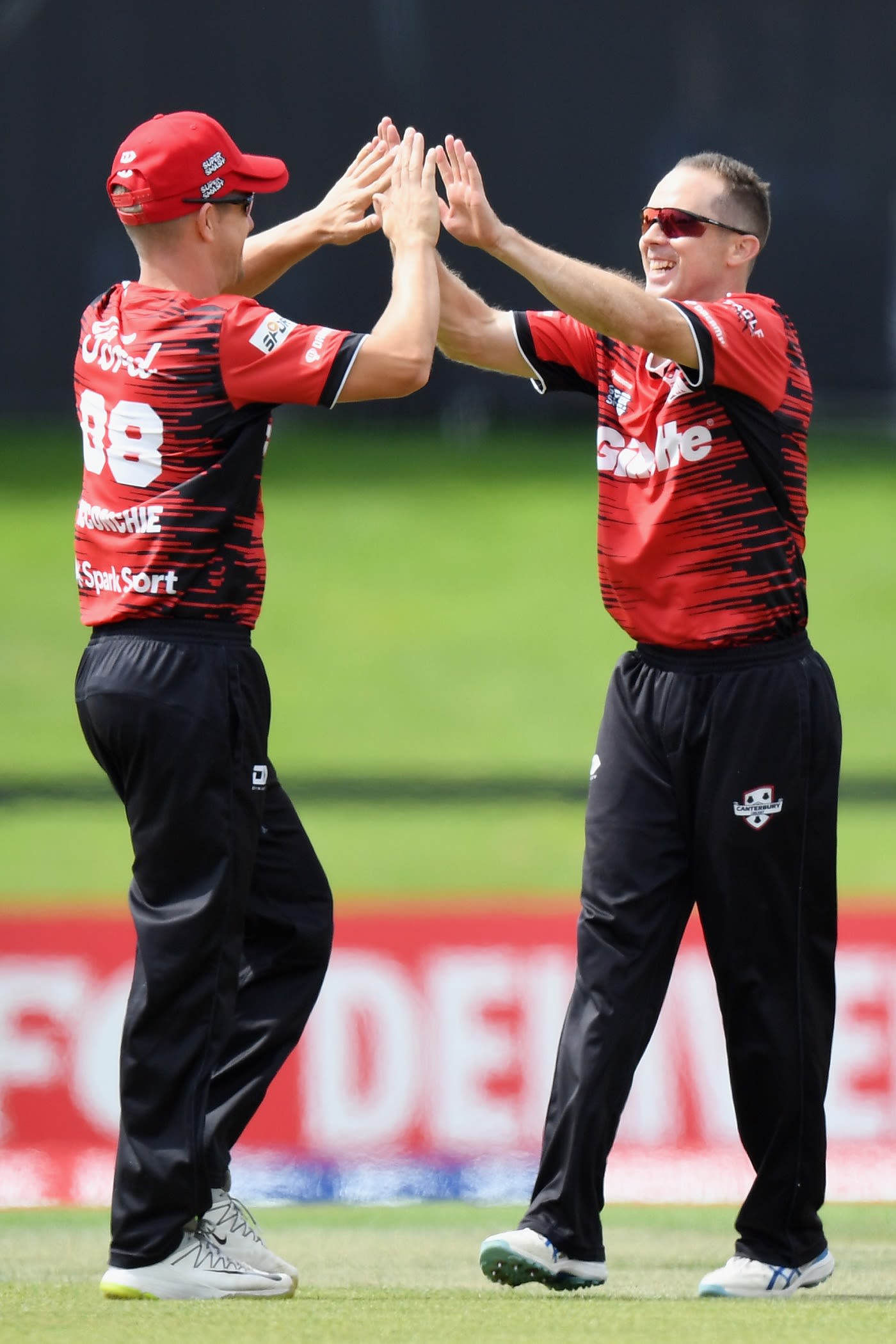 Todd Astle is congratulated by Cole McConchie after picking up a wicket