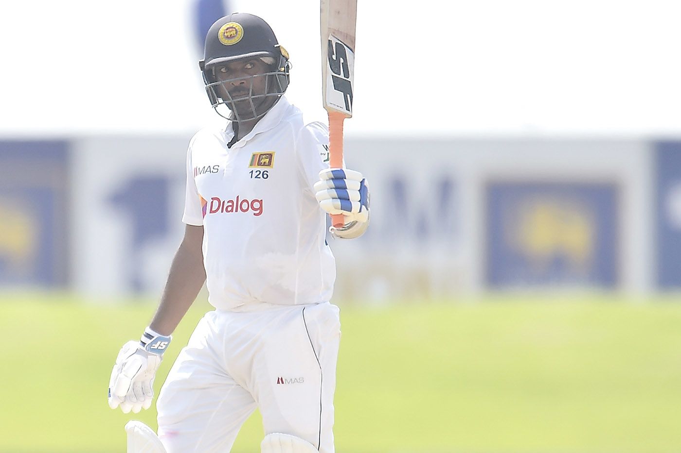 Dilruwan Perera raises his bat for fifty