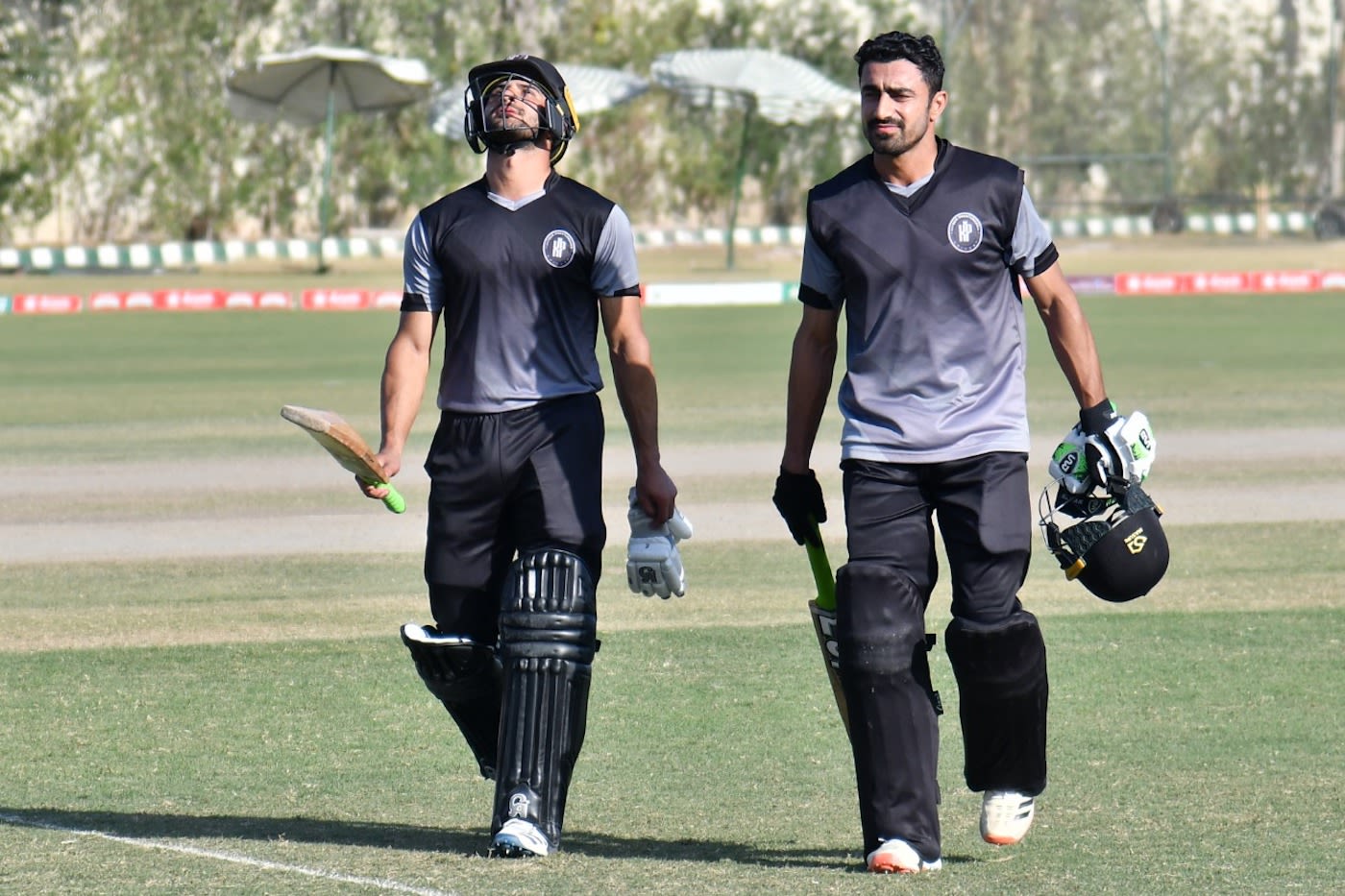 Sahibzada Farhan (left) and Adil Amin (right) walk back after Khyber Pakhtunkhwa's win