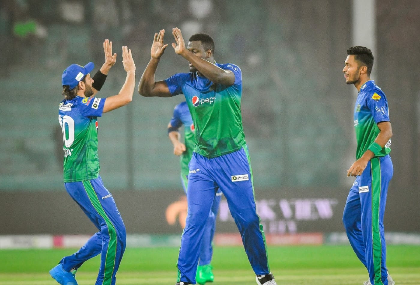 Shahid Afridi, Carlos Brathwaite and Mohammad Umar celebrate a wicket