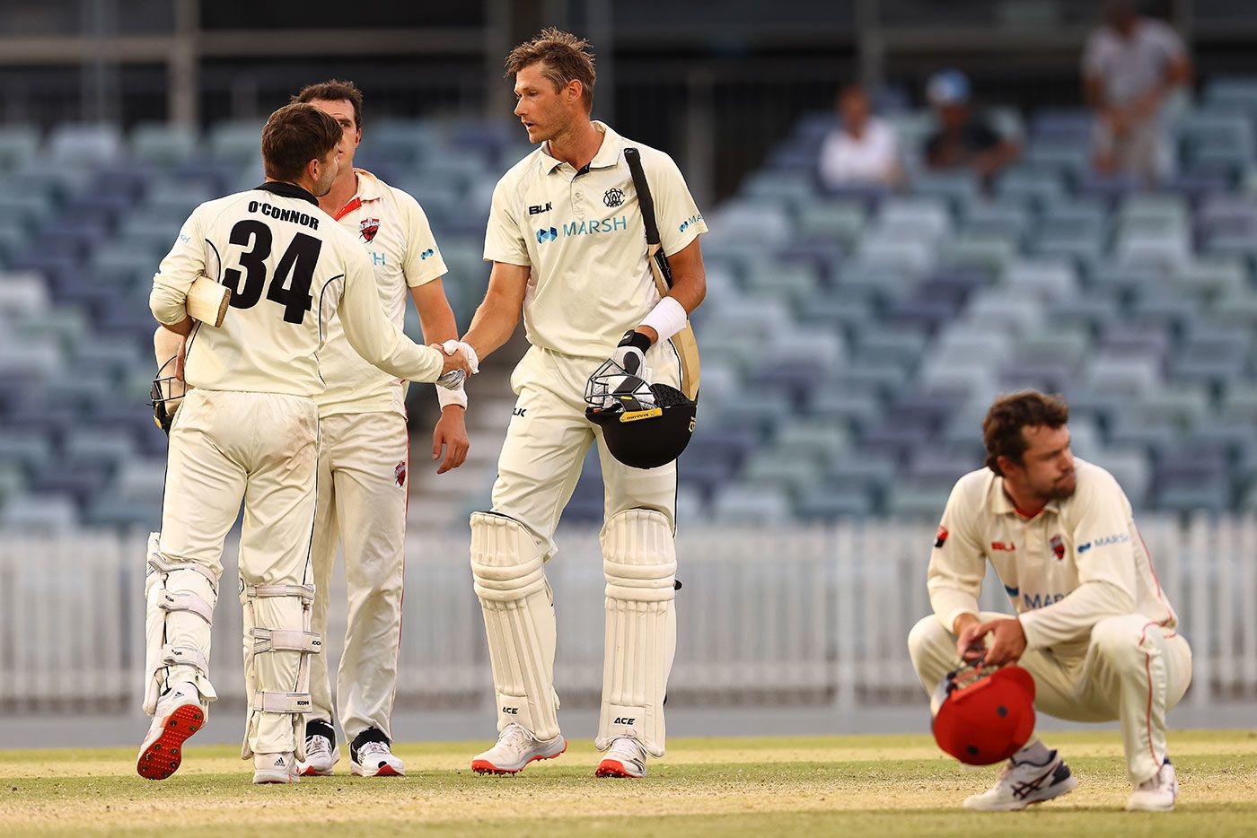 Western Australia's last pair, Cameron Gannon and Liam O'Connor, shake hands as Travis Head rues the near miss