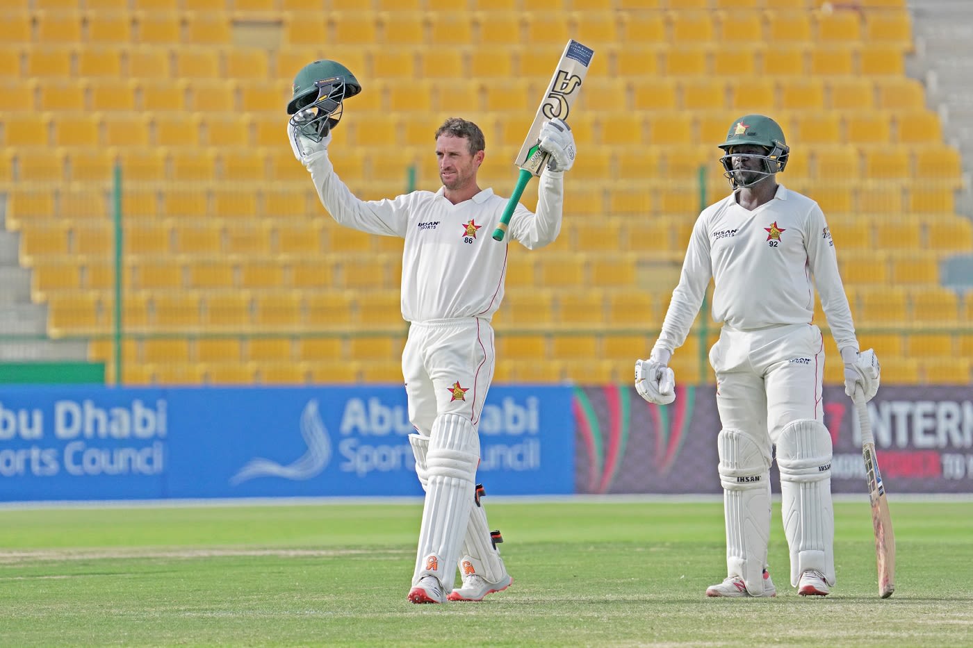 Sean Williams celebrates his hundred in Donald Tiripano's company