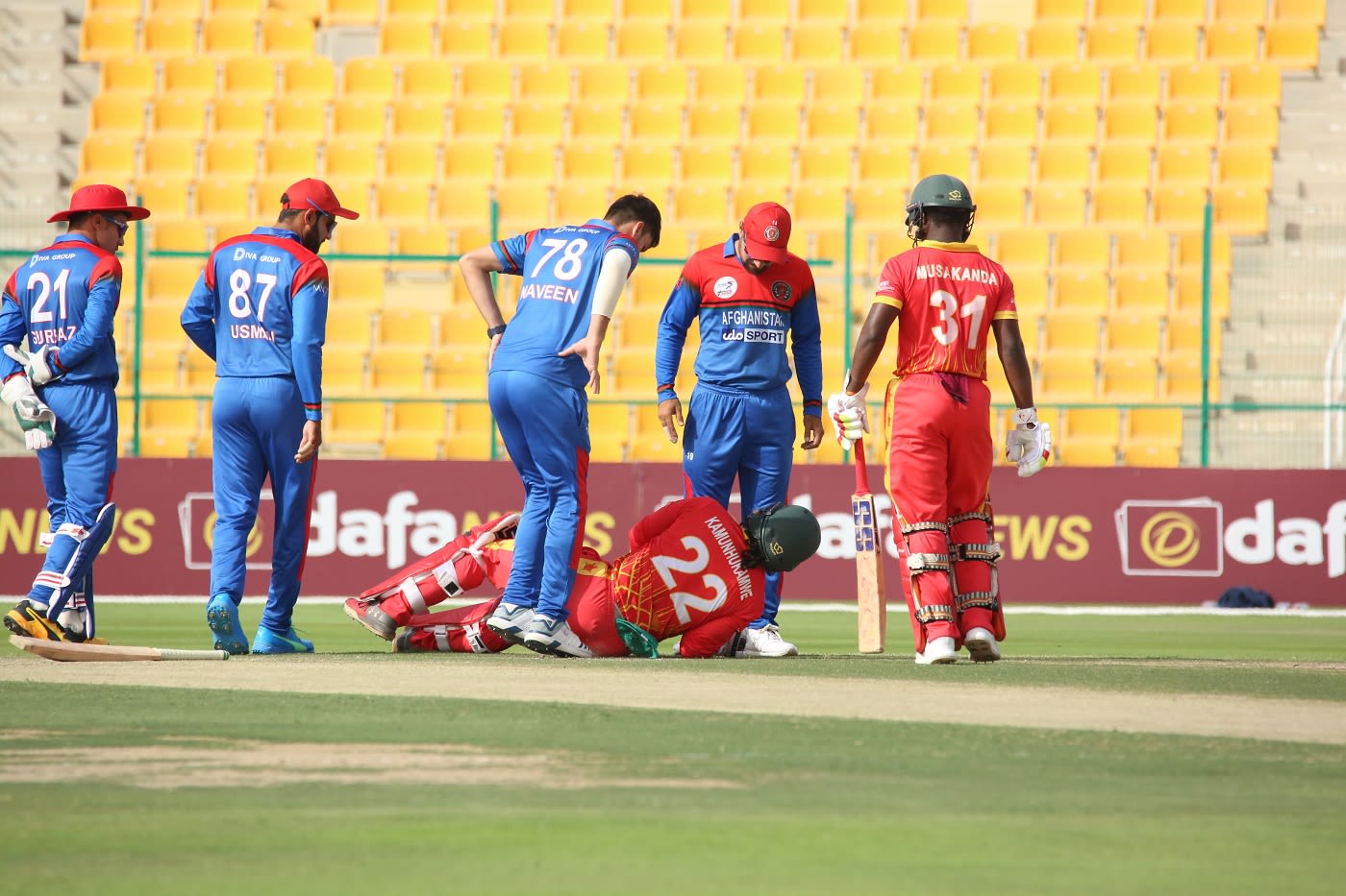 Tinashe Kamunhukamwe hits the ground after being struck by a Naveen-ul-Haq delivery
